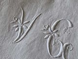 a white towel with a monogram and a flower on it