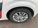 a close up of a car ' s tire on the street
