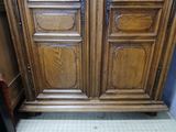 a large wooden cabinet with a mirror on top of it