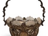 an antique silver plated basket with a handle and handles