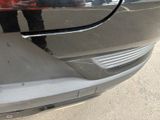 a reflection of a man in a mirror on the side of a car