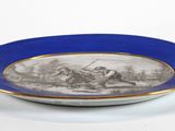 a blue and white plate with a picture of a soldier on it