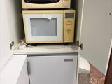 two microwaves stacked on top of each other in the kitchen