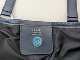 an image of a black and blue bag with a tag on it
