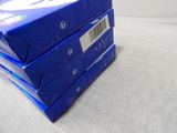 three blue boxes stacked on top of each other on a table