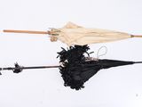 two umbrellas that have been left on the ground