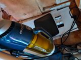 a vacuum that is sitting on the floor next to a wall