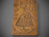 an old wooden plaque with a boat and trees on it