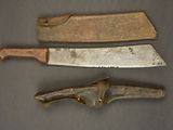 two old knives are sitting next to each other on a table