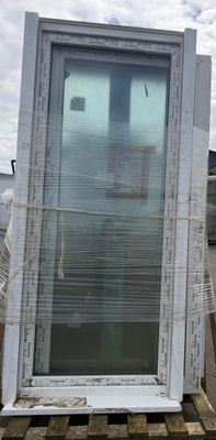 a large window sitting on a pallet in a parking lot