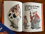 an open book with a picture of a cow and a man