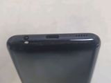 the back of a black cell phone sitting on top of a table