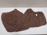 pair of brown pants laying on top of a white table