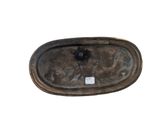 a small oval metal object with a tag on it