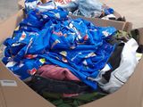 a cardboard cart with clothes in it in a warehouse