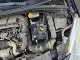 a car engine with the hood open and a car battery in it