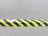 a yellow and black striped box on a gray surface