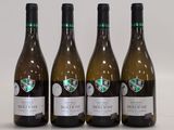 trois bouteilles de vin blanc sont alignées sur une table