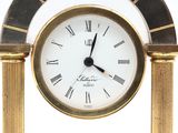 a gold clock with roman numerals on it