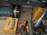 a pile of tools sitting on the floor in a garage