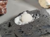 a rock that has a ball in it and some rocks