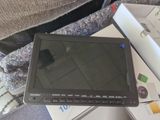 a tablet computer sitting on top of a pile of books