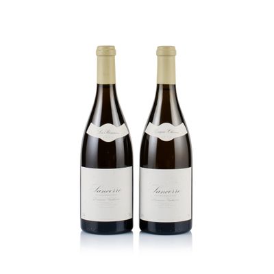 two bottles of wine sitting next to each other on a white surface