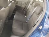 the interior of a blue car with two rows of seats in it