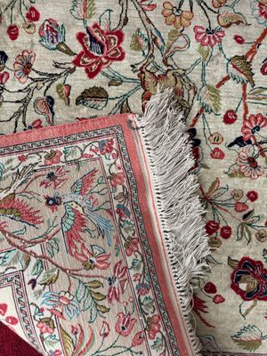an image of a close up of a rug with a bird on it