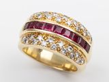 a close up of a gold ring with rubies and diamonds