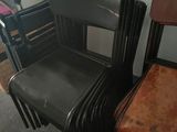 four black chairs sitting next to each other in a room