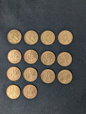 six different types of gold coins on a black surface