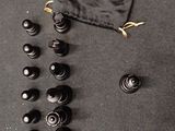a lot of black and white chess pieces on the table