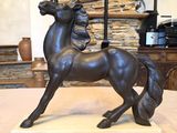 a statue of a horse that is standing on a table