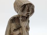statue of a woman talking on a cell phone on a white surface