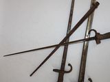 two old swords on a white surface with a white background