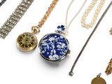 many different types of necklaces on a white surface