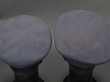 pair of black and blue sued boots on a gray background