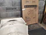 a toilet in the middle of the floor next to a box