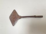 a metal spatula on a white surface with a white background