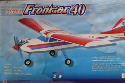 the box is open to show the model of a small plane