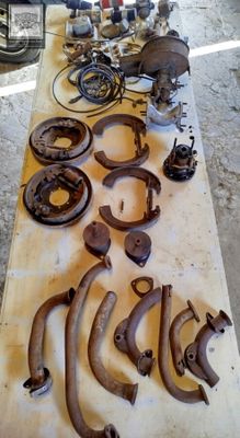 a table with a lot of old rusted parts on it