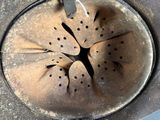 a metal tea pot with a tea strainer attached to it