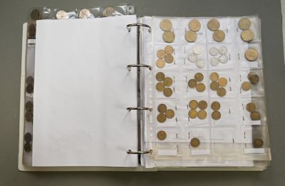 an open book with a bunch of coins on it