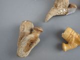 four pieces of carved animal figurines sitting on a table