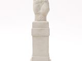 statue of a hand with a raised finger on a white background