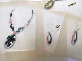 several pieces of jewelry are displayed on a table with papers
