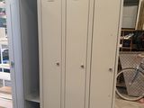 two lockers in a garage with a bike in the background