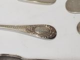 five spoons and two spoons sitting on a table