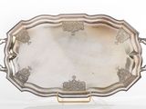 an ornate silver tray with handles and handles on a stand